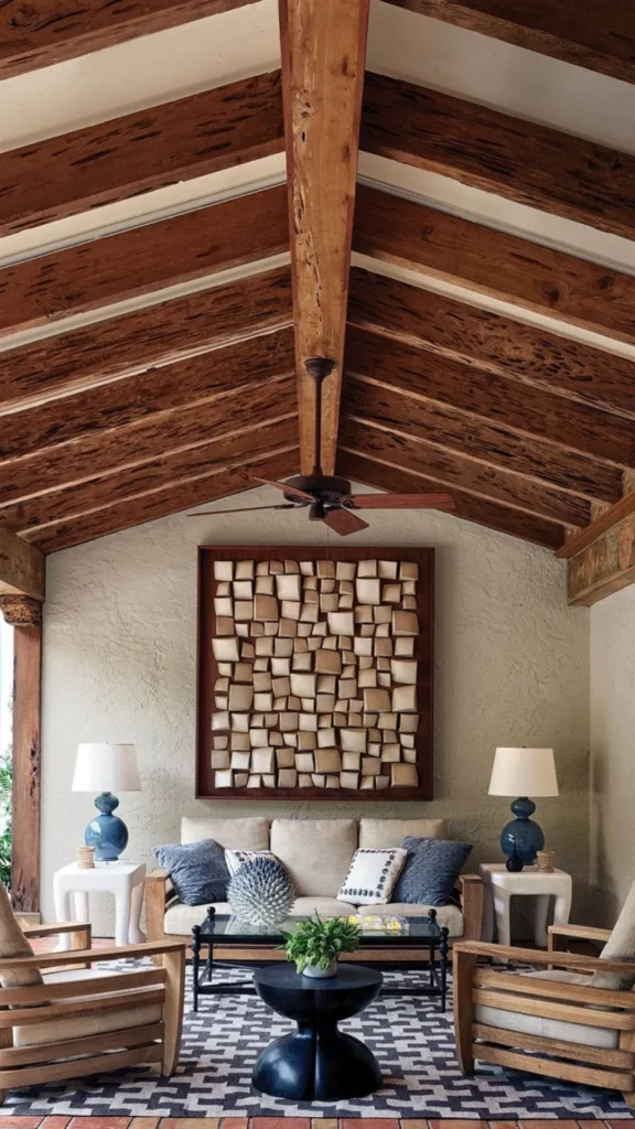 Mediterranean inspired summer home decor with exposed dark wood ceiling beams, a neutral sofa, and blue ceramic accent lamps.