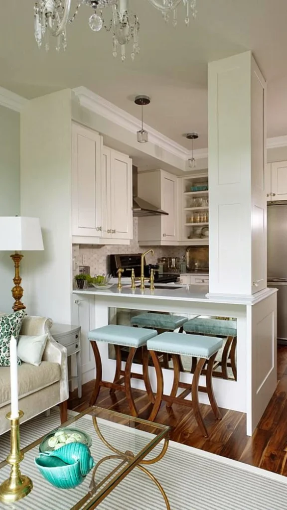 Glamorous condo layout for small apartment decor with a mirror-backed breakfast bar, light blue stools, and a cream sofa with leopard print pillows.