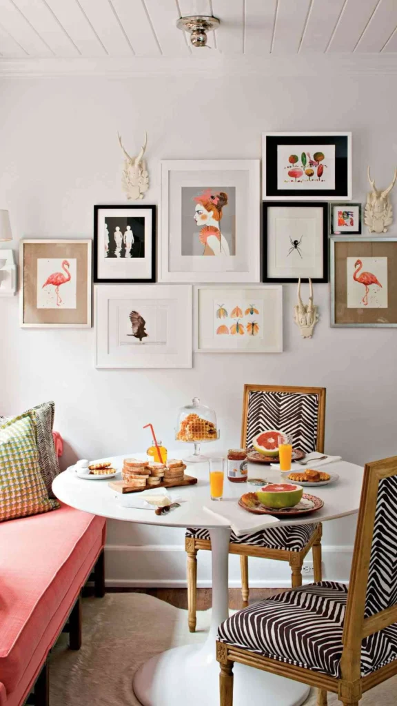 Vibrant breakfast nook featuring wall decor ideas with an asymmetrical gallery wall of flamingo art, portraits, and insect illustrations.
