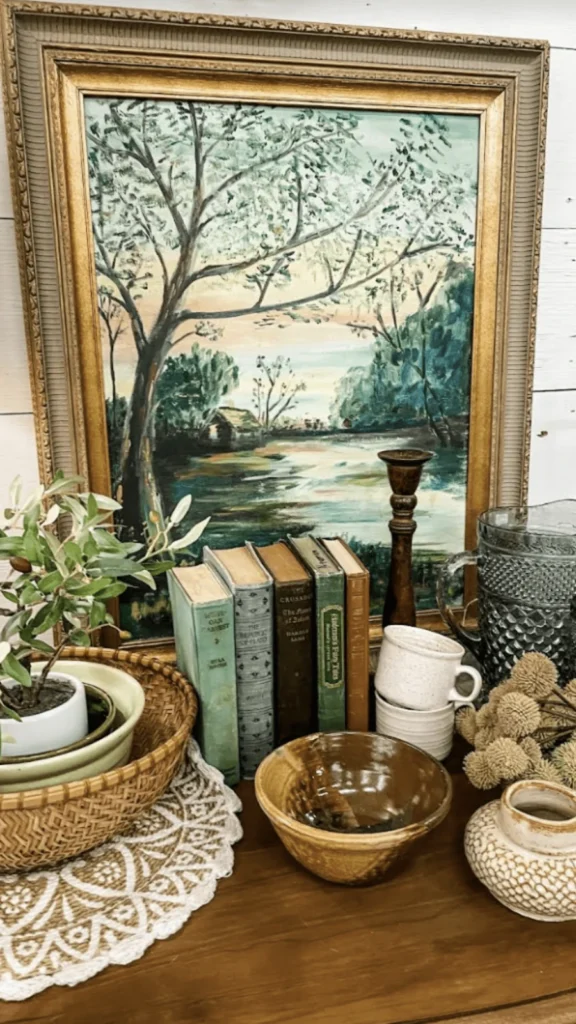 Spring cottage living room with vintage home decor featuring a tan leather sofa, fresh green plants, and a rustic wooden bowl with spring decorations.
