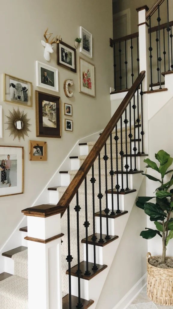Bright home staircase showing wall decor ideas with framed family photos, a gold starburst mirror, and a decorative white deer mount.