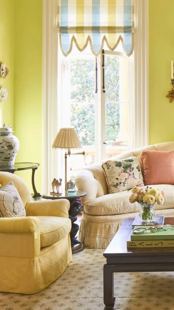 Bright sunny yellow living room featuring vintage home decor with a white curved sofa, a yellow tufted armchair, and a collection of decorative wall plates.