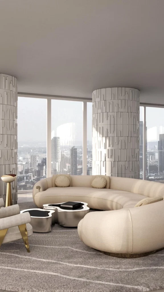 Luxury high-rise apartment displaying curved sofas with a massive cream curved sectional, textured white columns, gold accent chairs, and city views.
